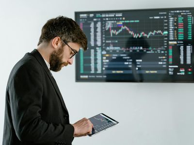 Professional investor analyzing market data on mobile device